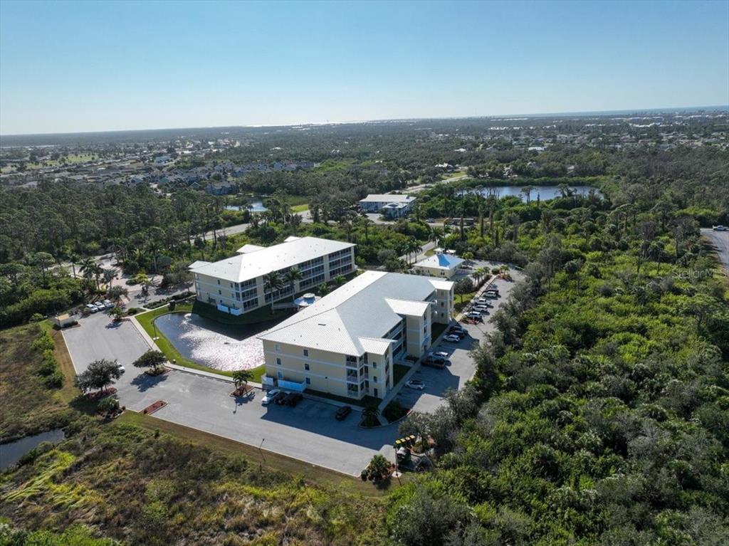 102 Natures Way, Unit 2101 Rotonda West, FL 33947 - Photo 37 of 49 an aerial view of a house with a yard