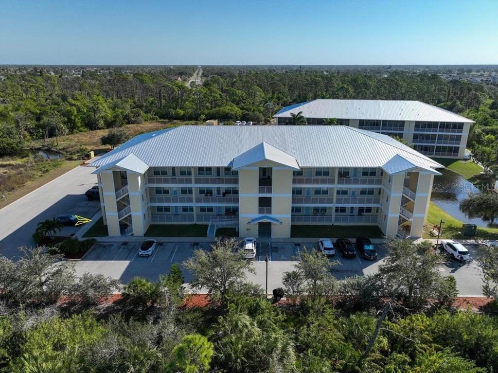 102 Natures Way, Unit 2101 Rotonda West, FL 33947 - Photo 42 of 49 an aerial view of a house with a yard