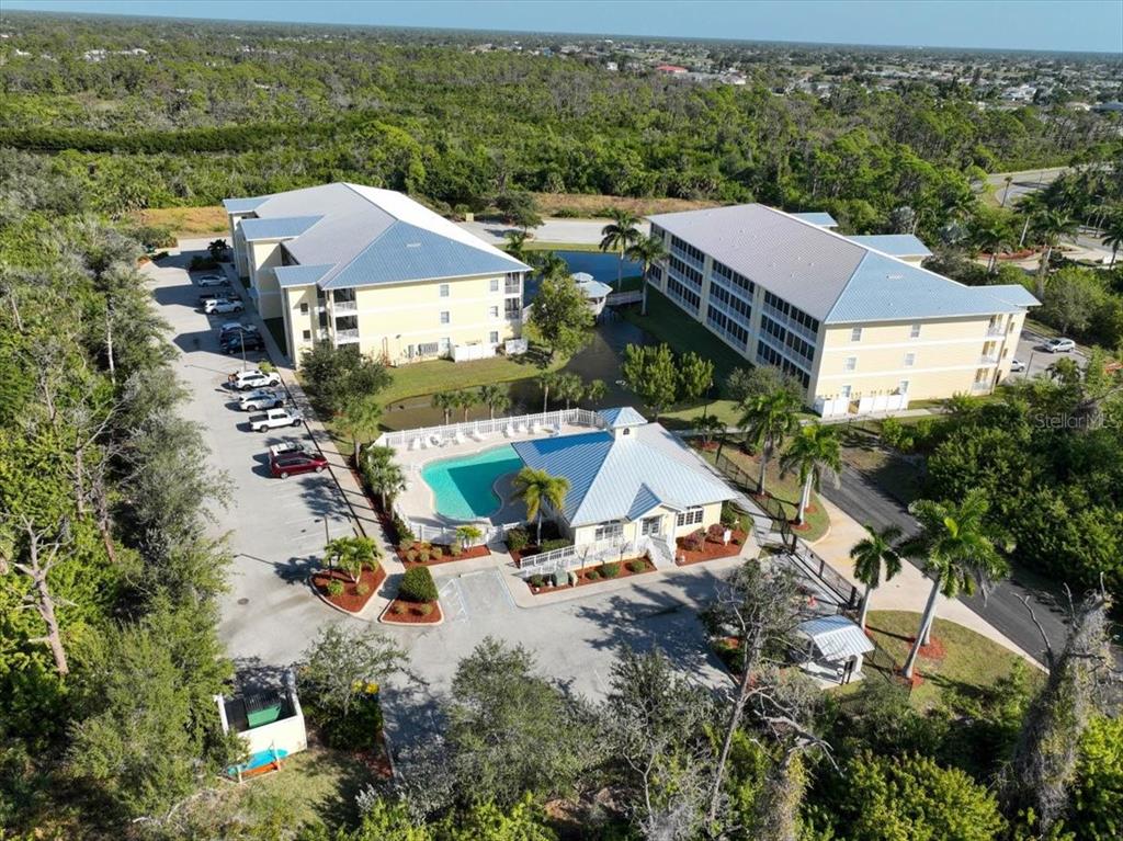 102 Natures Way, Unit 2101 Rotonda West, FL 33947 - Photo 43 of 49 an aerial view of multiple houses with yard
