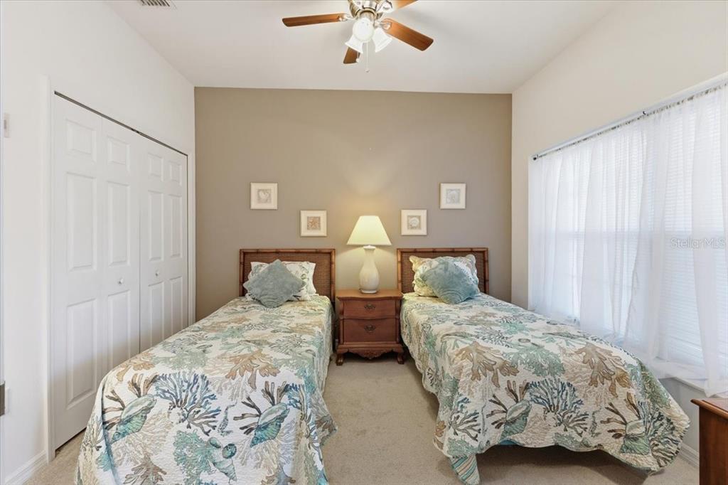 102 Natures Way, Unit 2101 Rotonda West, FL 33947 - Photo 5 of 49 a bedroom with two beds and lamp