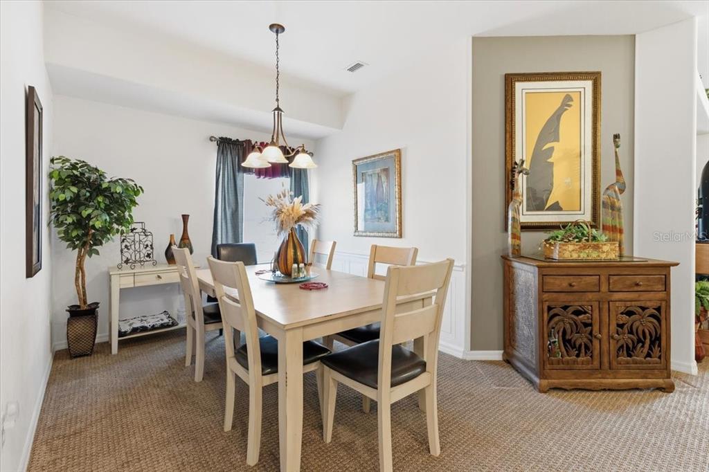 102 Natures Way, Unit 2101 Rotonda West, FL 33947 - Photo 10 of 49 a view of a dining room with furniture window and wooden floor