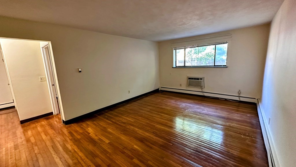 8 Riverside Street, Unit 13 Watertown, MA 02472 - Photo 12 of 18 a view of an empty room with wooden floor and a window