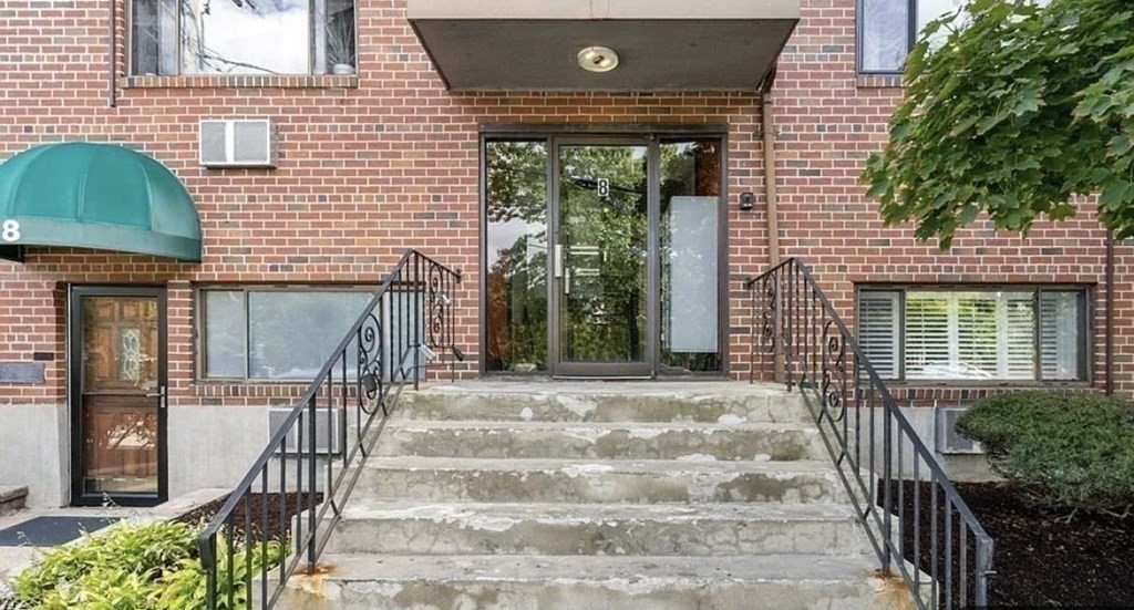8 Riverside Street, Unit 13 Watertown, MA 02472 - Photo 2 of 18 a front view of a house with a garden
