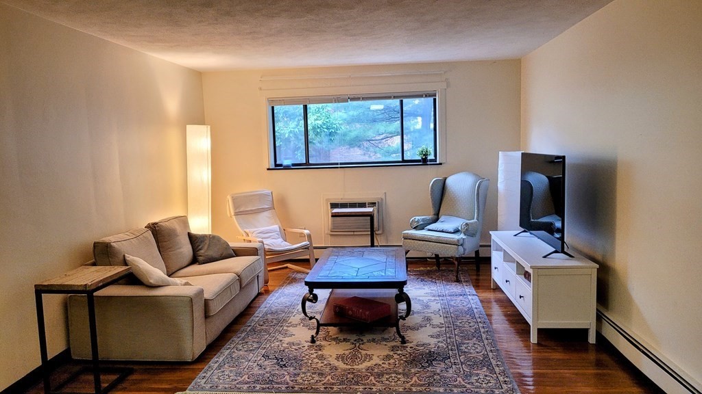 8 Riverside Street, Unit 13 Watertown, MA 02472 - Photo 7 of 18 a living room with furniture and a window
