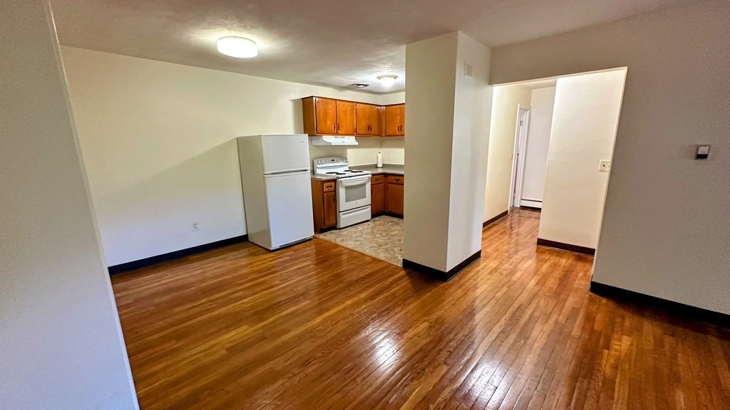 8 Riverside Street, Unit 13 Watertown, MA 02472 - Photo 9 of 18 a view of kitchen with utility room and wooden floor