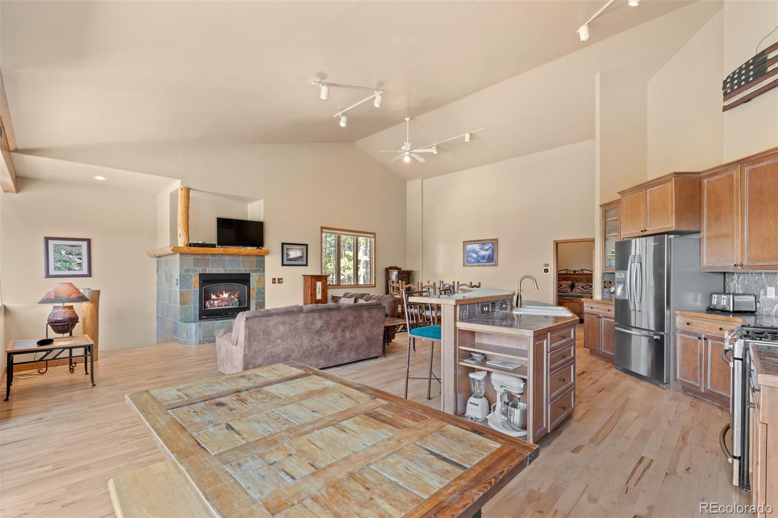 92 Emmett Lode Road, Unit B Breckenridge, CO 80424 - Photo 15 of 50 a living room with stainless steel appliances furniture a fireplace a flat screen tv and view kitchen