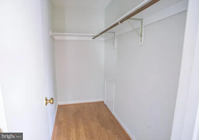 a view of walk in closet with empty racks