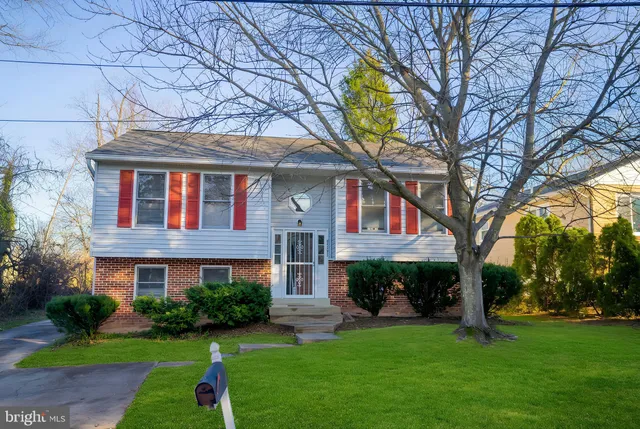 a front view of a house with a garden and plants