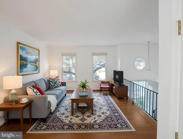 a living room with furniture and a rug
