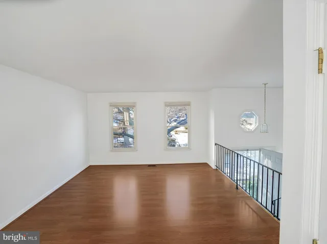a view of room with window and wooden floor