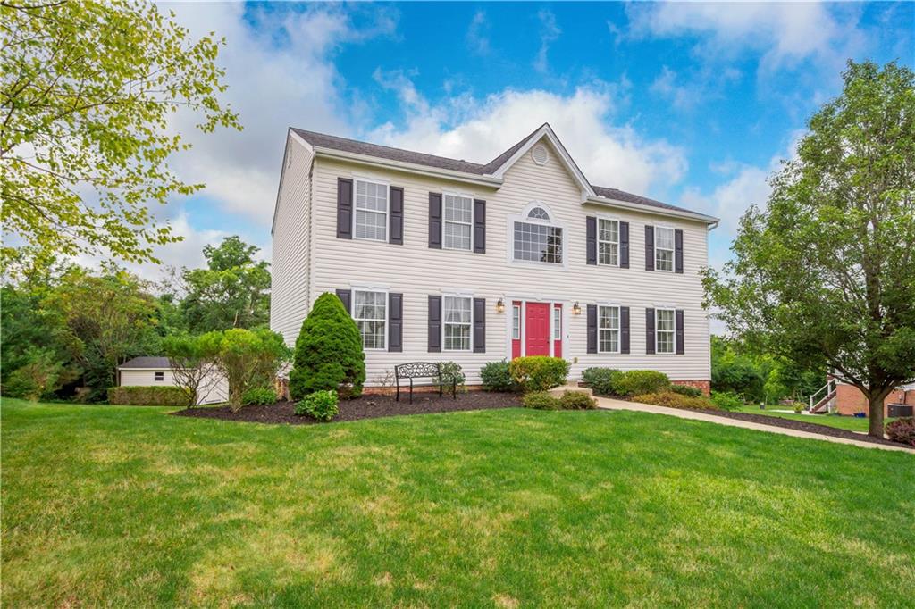 a view of a house with a yard and sitting area