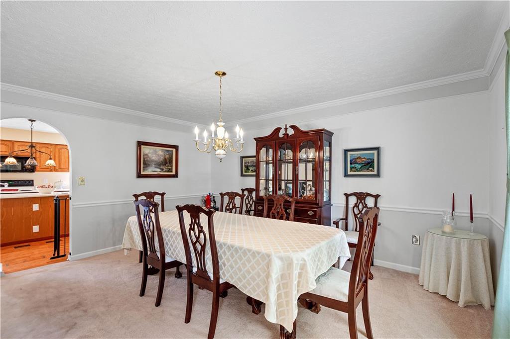 136 Maclaine Drive Carnegie, PA 15106 - Photo 12 of 30 a view of a dining room with furniture and chandelier