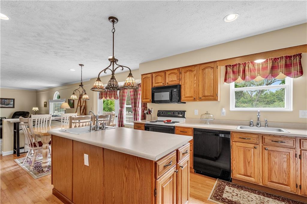 136 Maclaine Drive Carnegie, PA 15106 - Photo 13 of 30 a kitchen with stainless steel appliances granite countertop a sink stove and refrigerator