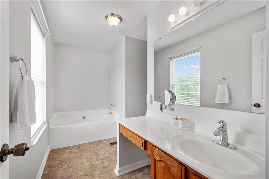 136 Maclaine Drive Carnegie, PA 15106 - Photo 22 of 30 a bathroom with a sink double vanity granite tub shower and a mirror