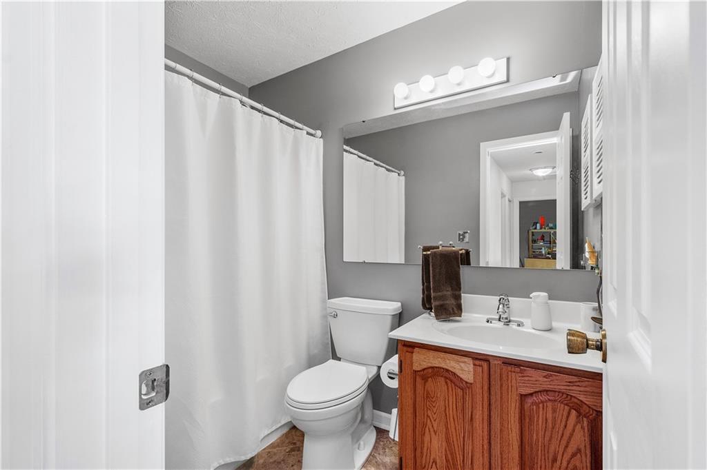 136 Maclaine Drive Carnegie, PA 15106 - Photo 23 of 30 a bathroom with a granite countertop sink toilet and mirror