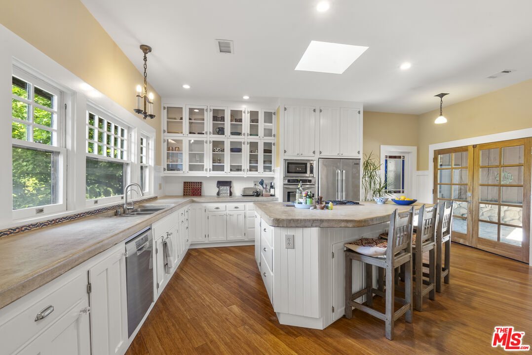 15454 South Mountain Road Oxnard, CA 93036 - Photo 18 of 65 a kitchen with stainless steel appliances granite countertop a stove and a wooden floors