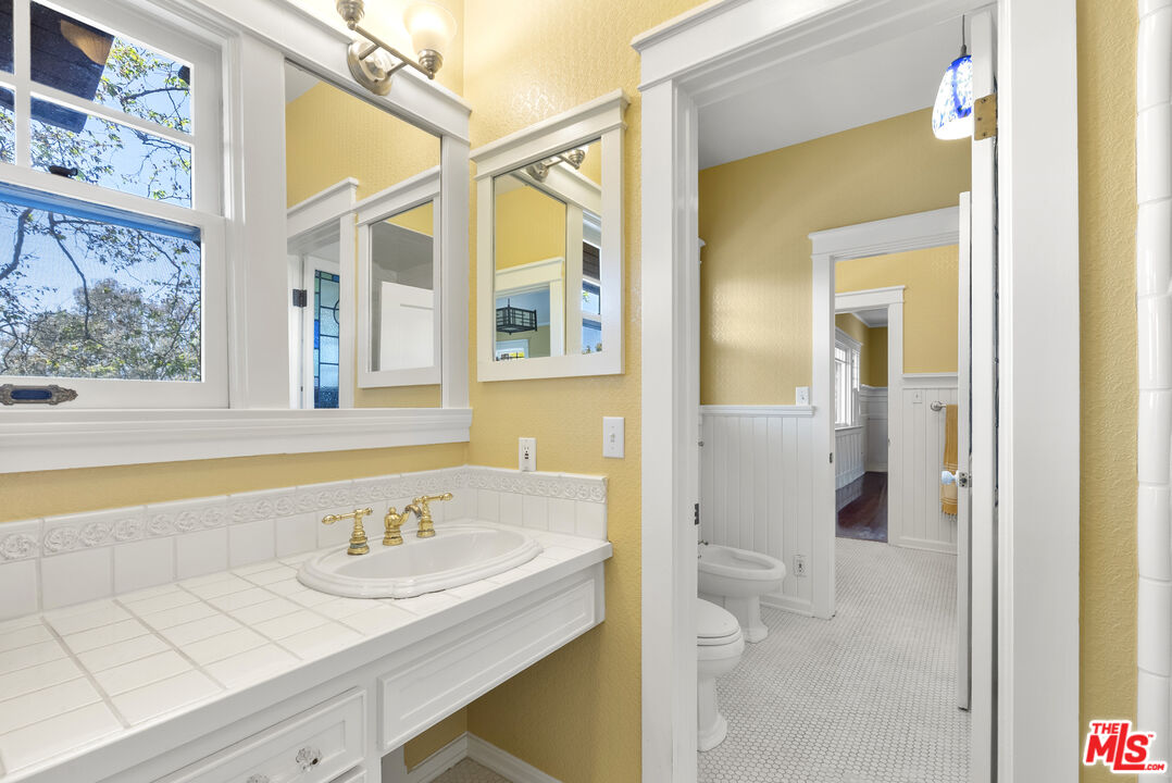 15454 South Mountain Road Oxnard, CA 93036 - Photo 26 of 65 a bathroom with a granite countertop sink and a mirror