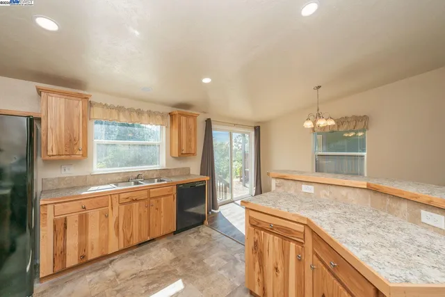 a large kitchen with kitchen island a sink stainless steel appliances and cabinets