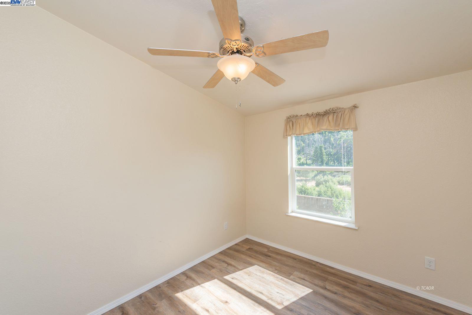 38500 Highway 299 Junction City, CA 96048 - Photo 25 of 49 an empty room with a window and a fan