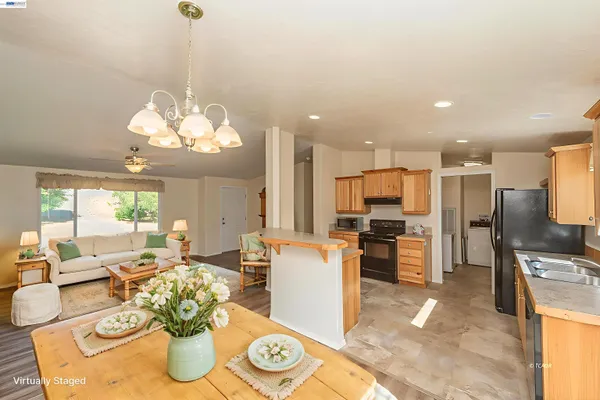 a large kitchen with a table and chairs