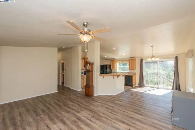 a view of a kitchen with wooden floor and a kitchen