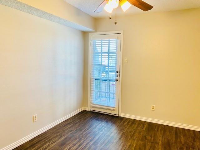 7621 McCallum Boulevard, Unit 108 Dallas, TX 75252 - Photo 15 of 26 an empty room with wooden floor fan and windows