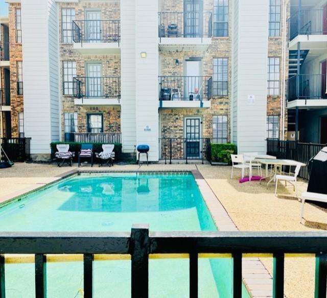 7621 McCallum Boulevard, Unit 108 Dallas, TX 75252 - Photo 22 of 26 a view of swimming pool with a lounge chairs
