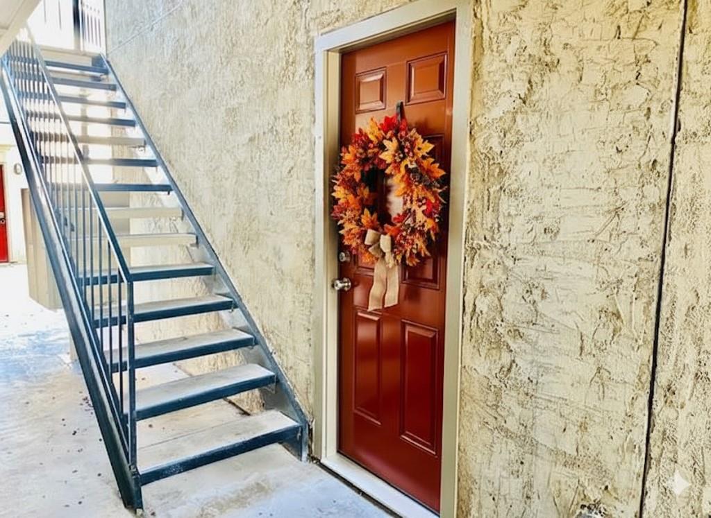 7621 McCallum Boulevard, Unit 108 Dallas, TX 75252 - Photo 4 of 26 wooden floor with staircase and windows