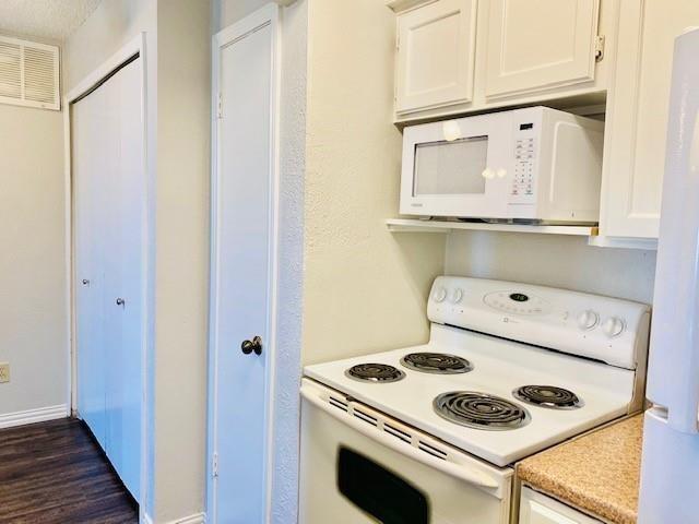 7621 McCallum Boulevard, Unit 108 Dallas, TX 75252 - Photo 7 of 26 a kitchen with a stove and white cabinets