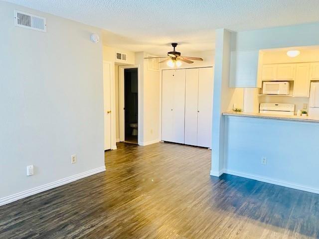 7621 McCallum Boulevard, Unit 108 Dallas, TX 75252 - Photo 10 of 26 an empty room with wooden floor and windows
