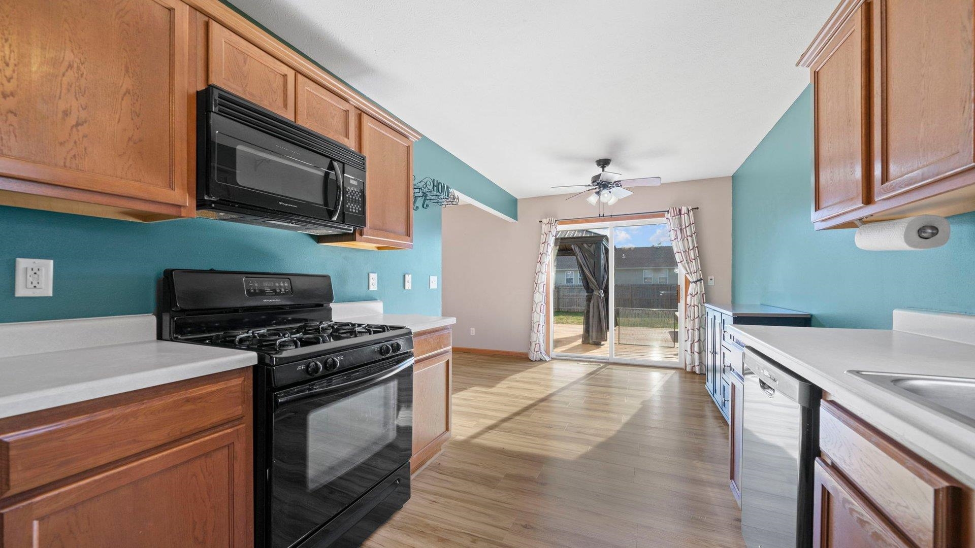 658 Cassandra Way South Beloit, IL 61080 - Photo 11 of 25 a kitchen with stainless steel appliances a stove microwave and sink