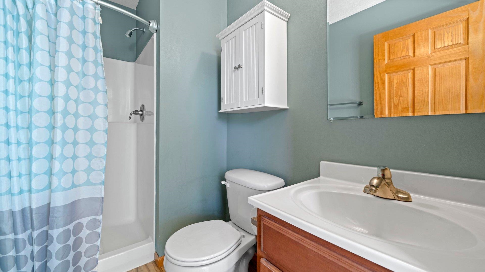 658 Cassandra Way South Beloit, IL 61080 - Photo 19 of 25 a bathroom with a sink a toilet and shower curtain