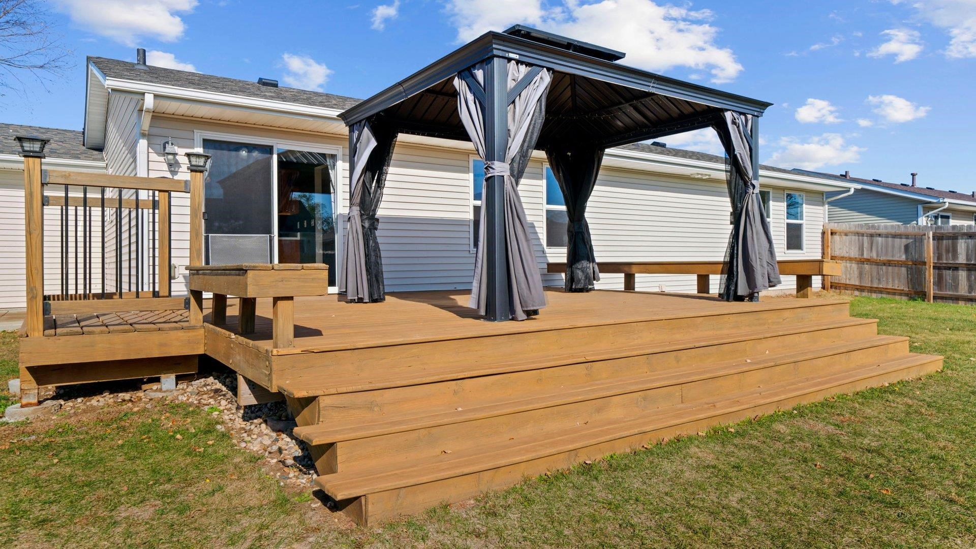 658 Cassandra Way South Beloit, IL 61080 - Photo 22 of 25 a view of a balcony with chairs and wooden fence