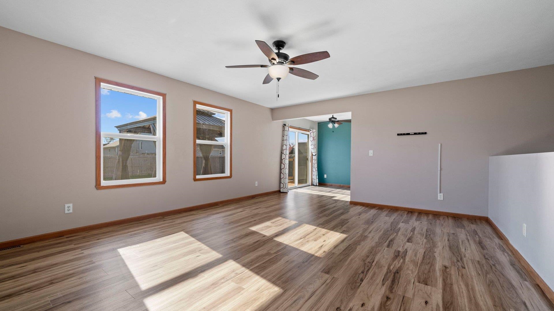 658 Cassandra Way South Beloit, IL 61080 - Photo 4 of 25 a view of an empty room with wooden floor and a window