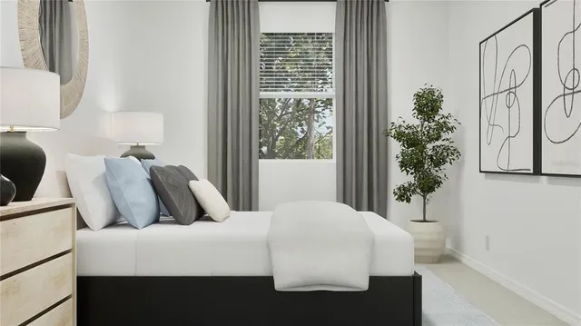 a bedroom with a large bed and a potted plant next to a window