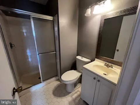 a white toilet sitting next to a bathroom sink