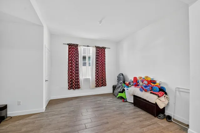 a kitchen with stainless steel appliances granite countertop a table chairs sink refrigerator and cabinets