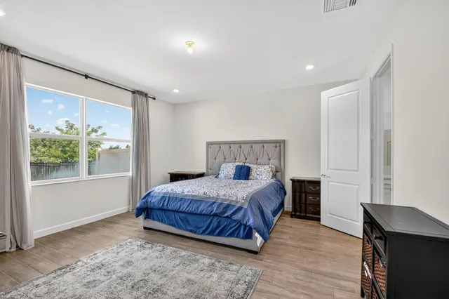 a bedroom with a bed and a window