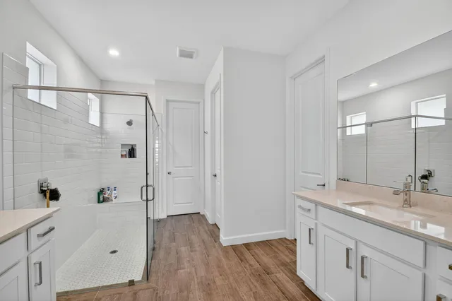a bathroom with a sink a toilet and shower