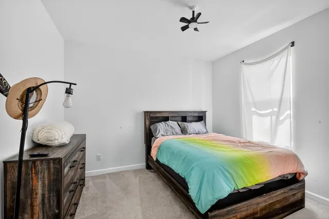 a view of a patio with table and chairs with wooden floor and fence