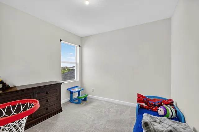 a living room with furniture gym equipment and a large window