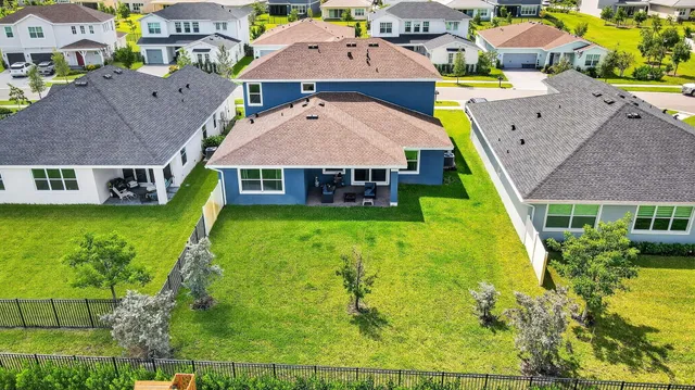 an aerial view of a house with yard swimming pool and outdoor seating