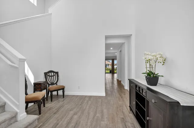 a living room with furniture a wooden floor and a large window