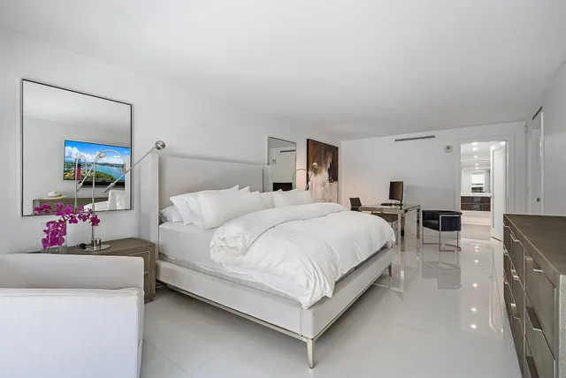 a bed room with a bed window and a mirror