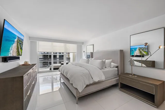 a bedroom with a bed a bookshelf a desk and chair