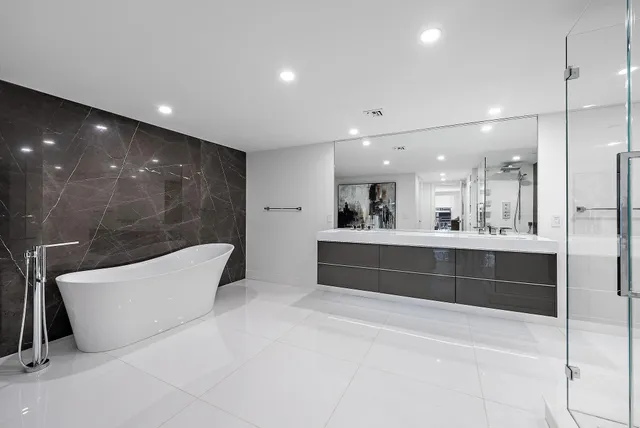 a bathroom with a double vanity sink a mirror and shower