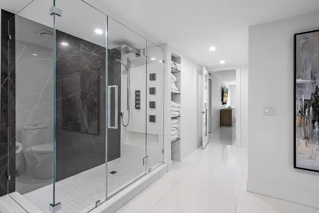a bathroom with a shower and a glass door