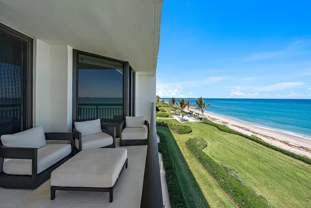 a balcony with chairs and a table