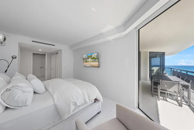 a bedroom with a bed and a table