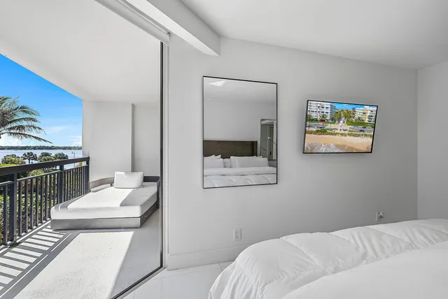 a bedroom with a bed and a mirror